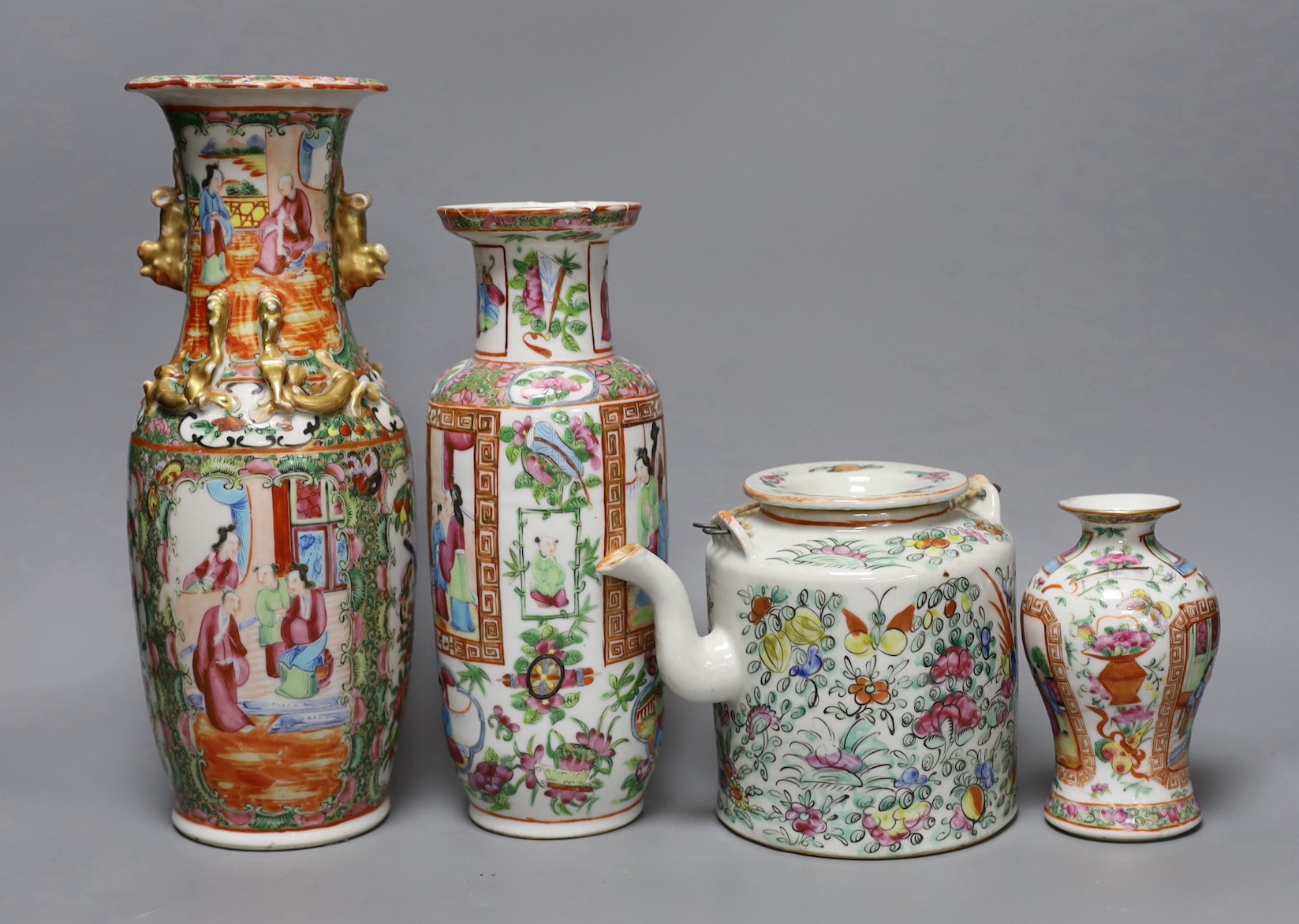 Three Chinese famille rose vases and a teapot, late 19th/early 20th century, tallest vase 29.5 cms high